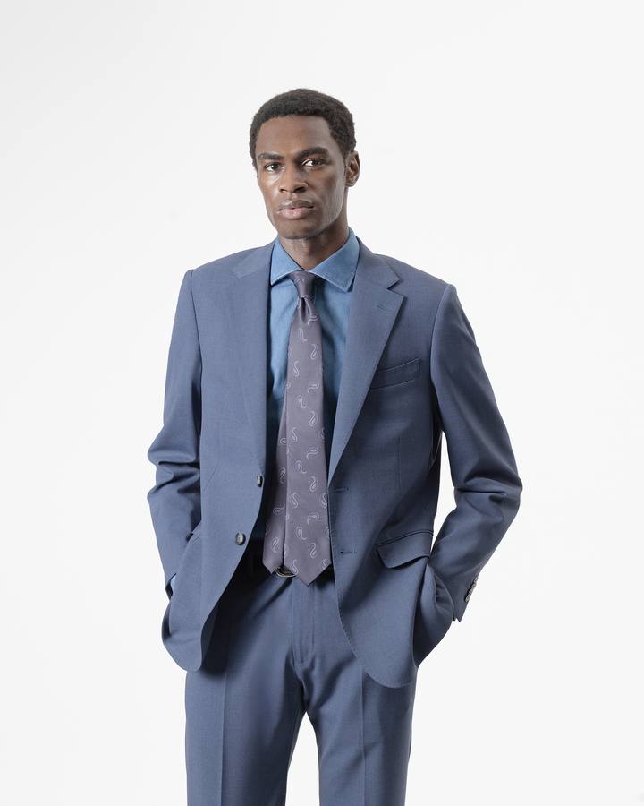 Traje 2 piezas con lana azul niágara de PuroEgo en plano medio, con camisa azul y corbata.
