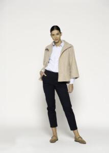 Chaqueta corta beige con cuello vuelto y un botón, vista frontal.