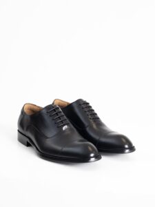 El par de zapatos oxford negros PuroEgo en vista de tres cuartos