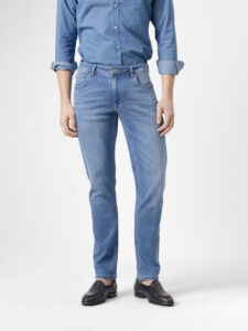 Jeans slim fit azul medio de PuroEgo en tres cuartos: se ve el costado, el bolsillo delantero y la caída de la pierna.
